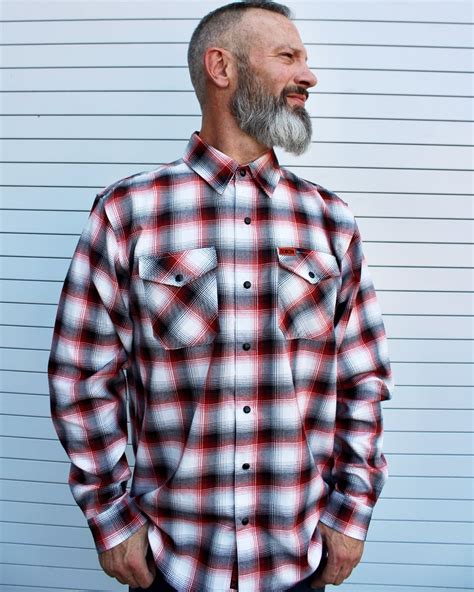 Dixon flannel co - Men’s brown, black, and white plaid patterned flannel shirt. Full button up closure. Dual button down flap chest pockets. Collar-stay buttons. Center box pleat. Machine washable. Signature D-Tech™ polyester blend for minimal shrinking and wrinkling. Imported. 